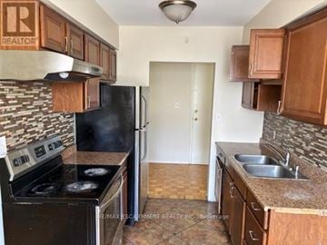 Hamilton (Glenview) multi-family for rent - A kitchen with a stove, sink, and cabinets.