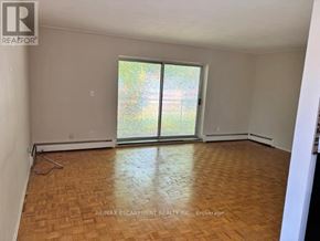 Hamilton (Glenview) multi-family for rent - A room with a wooden floor and a sliding glass door.