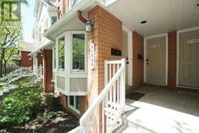 Ottawa townhouse for rent - A white porch with a white railing and a white door with a number 525 on it.