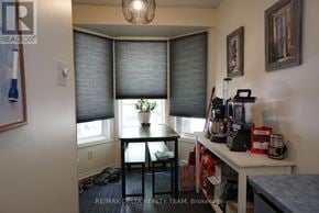 Ottawa townhouse for rent - A room with a table, chairs, and a window with blinds.