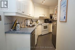 Ottawa townhouse for rent - A kitchen with white cabinets and a fridge.