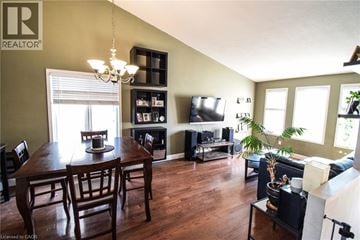 Beamsville apartment for rent - A living room with a wooden table and chairs.