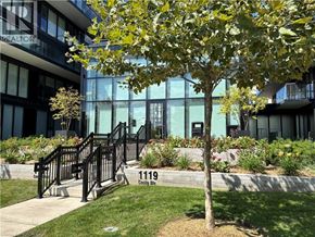Burlington condo for rent - A tree in front of a building with the number 1119 on it.