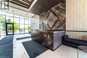 Burlington condo for rent - A modern reception area with a wooden reception desk and black and white carpeting.