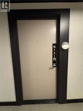 Burlington condo for rent - A black door with a sign that says B121 on it.