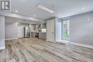Aurora apartment for rent - A spacious kitchen with wood flooring and white walls.