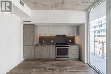 Toronto (South Riverdale) condo for rent - A modern kitchen with a stove top oven and a microwave.