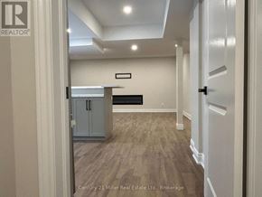 Oakville (Ro River Oaks) apartment for rent - A real estate listing photo of a room with a wooden floor and white walls.