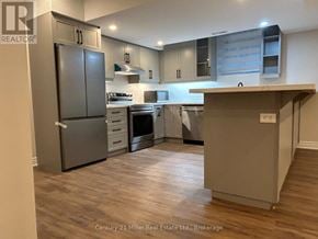 Oakville (Ro River Oaks) apartment for rent - A kitchen with a refrigerator, oven, and cabinets.