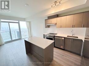 Vaughan (Vellore Village) condo for rent - A modern kitchen with a large island in the middle.