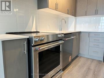 Vaughan (Vellore Village) condo for rent - A modern kitchen with a stainless steel oven and white countertops.
