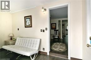 Wasaga Beach apartment for rent - A white sofa sits in a room with a doorway leading to another room.