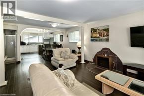 Wasaga Beach apartment for rent - A living room with a couch, a fireplace, and a television.