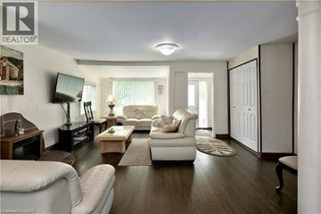 Wasaga Beach apartment for rent - A living room with a white couch and a wooden coffee table.