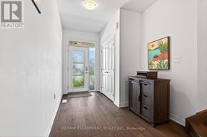 Brantford apartment for rent - A room with a wooden floor and a painting on the wall.