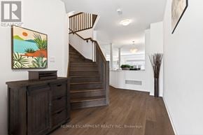 Brantford apartment for rent - A hallway with a staircase and a painting on the wall.