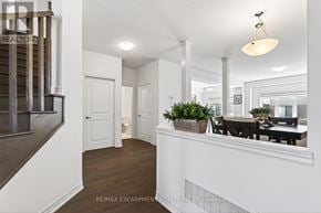 Brantford apartment for rent - A well-lit, spacious interior of a house with a dining area and a staircase.