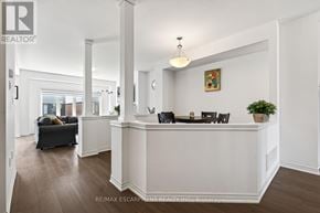 Brantford apartment for rent - A white reception desk with a plant on it and a framed picture on the wall.