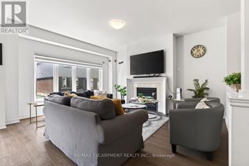 Brantford apartment for rent - A living room with a grey couch and a fireplace.