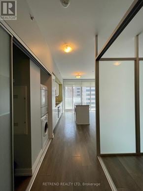 Toronto (Kensington-Chinatown) condo for rent - A hallway with a washer and dryer in it.