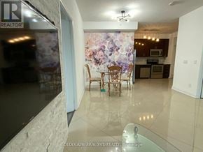 Vaughan (Beverley Glen) condo for rent - A dining room with a table and chairs is visible through a glass door.