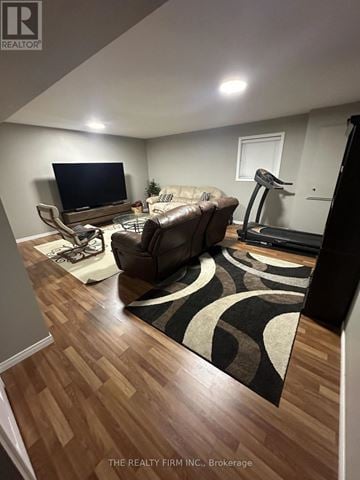 London East (East D) townhouse for rent - A living room with a brown couch and a television.