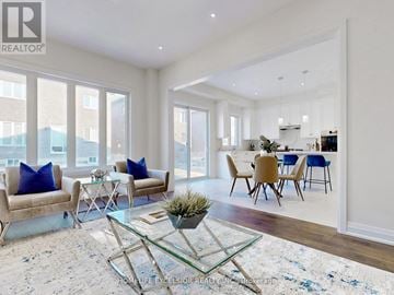 Richmond Hill (Oak Ridges) apartment for rent - A living room with a glass coffee table and blue cushions.