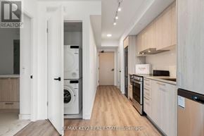 Vaughan (Vaughan Corporate Centre) condo for rent - A modern kitchen with wooden cabinets and stainless steel appliances.