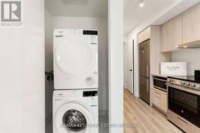 Vaughan (Vaughan Corporate Centre) condo for rent - A white washer and dryer stacked on top of each other in a laundry room.