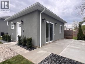 Harrow apartment for rent - A grey house with a white door and windows.