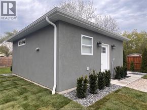 Harrow apartment for rent - A grey house with a white door and windows.