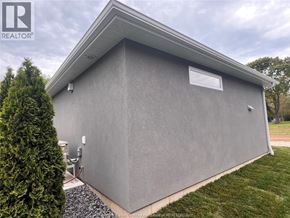 Harrow apartment for rent - A grey building with a small window and a sign that says REALTOR.
