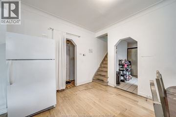 Windsor apartment for rent - A white refrigerator is in a kitchen with wood floors and white walls.