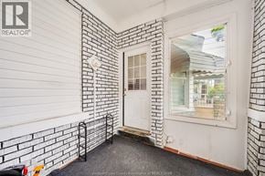 Windsor apartment for rent - A white door with a window is in a room with white walls.