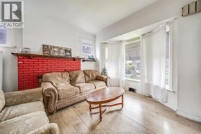 Windsor apartment for rent - A living room with a red brick fireplace and a wooden coffee table.