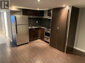 Toronto (South Riverdale) apartment for rent - A kitchen with a refrigerator, oven, and cabinets.