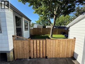 St. Thomas apartment for rent - A wooden fence in front of a house with a tree in the background.