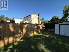 St. Thomas apartment for rent - A backyard with a wooden fence and a green lawn.