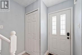London East (East I) townhouse for rent - A white door with a glass panel and sidelights is on the right.