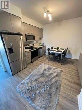 Grimsby (Grimsby Beach) condo for rent - A modern kitchen with a refrigerator, oven, and microwave.