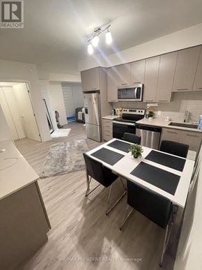 Grimsby (Grimsby Beach) condo for rent - A modern kitchen with a dining table set for four.