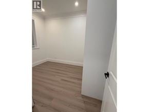 North Vancouver apartment for rent - A room with wooden flooring and white walls.