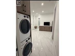 North Vancouver apartment for rent - A washing machine and dryer are stacked on top of each other.