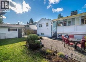 North Vancouver apartment for rent - A sunny day in a backyard with a patio table set for four.