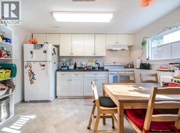 North Vancouver apartment for rent - A kitchen with a white fridge and wooden table.