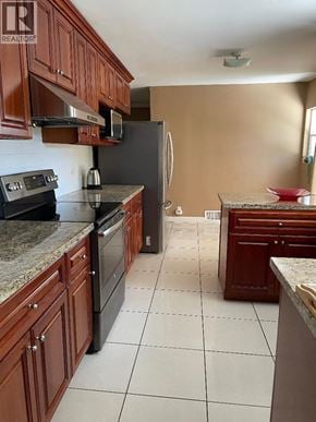 North Vancouver apartment for rent - A kitchen with brown cabinets and a black fridge.