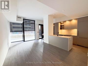 Toronto (Church-Yonge Corridor) townhouse for rent - A modern kitchen with a white countertop and wooden flooring.