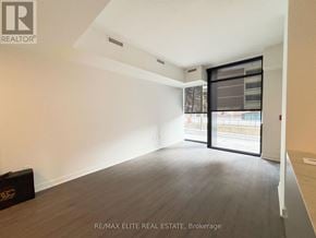 Toronto (Church-Yonge Corridor) townhouse for rent - A room with a large window and a sliding door leading to a balcony.