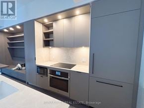 Toronto (Church-Yonge Corridor) townhouse for rent - A modern kitchen with stainless steel appliances and a marble countertop.