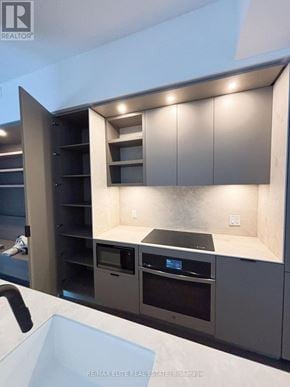 Toronto (Church-Yonge Corridor) townhouse for rent - A modern kitchen with a white countertop and stainless steel appliances.
